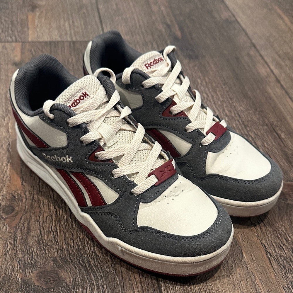 Kid’s crimson and gray Reebok sneakers